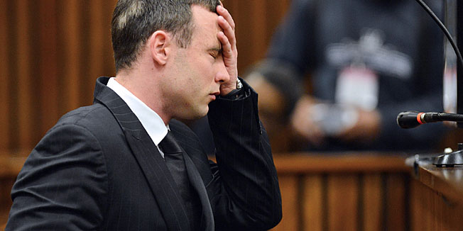 South African Paralympic athlete Oscar Pistorius sits in the dock at the High Court in Pretoria on June 30, 2014 after spending 30 days under psychiatric observation to determine if he should be held criminally responsible for the killing of his girlfriend Reeva Steenkamp. Pistorius resumed on June 30 with experts saying they had found no sign of mental illness after a month of psychiatric tests. 