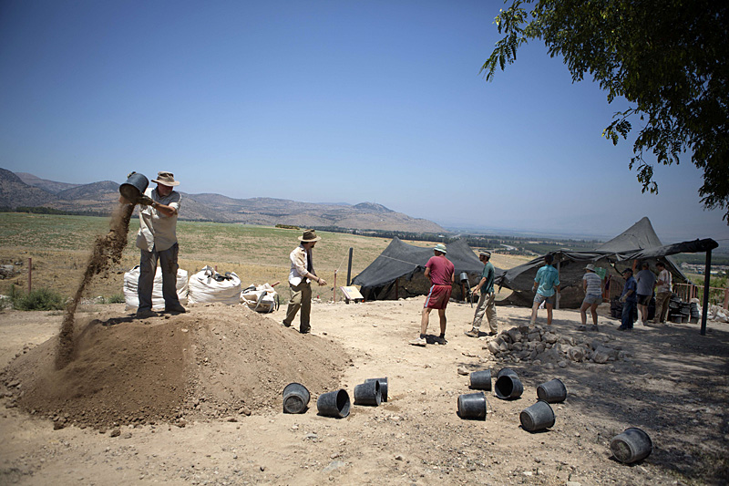 Volunteers of the Hebrew University work during an excavation in the Northern Israeli archeological site of the ancient Tel Hazor, where they found the remains of a Sphinx with a hieroglyphic inscription between its paws dating circa 3rd century BCE,  on July 9 2013.  The Sphinx was sculpted for Egyptian King Mycerinus, one of the builders of the Giza pyramids, and this is the first time ever a statue dedicated to Mycerinus has been uncovered, and the first time such a finding has been unearthed in the Levant.  AFP PHOTO/MENAHEM KAHANA