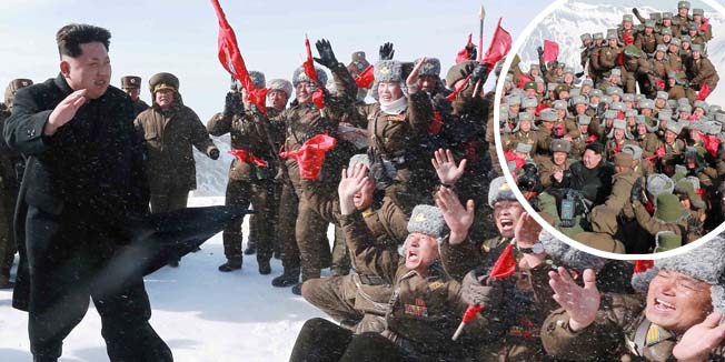 This photo taken on April 18, 2015 and released by North Korea's official Korean Central News Agency (KCNA) on April 20, 2015 shows North Korean leader Kim Jong-Un (foreground L) gesturing to cheering combat aircraft pilots of the Korean People's Army (KPA) on the snow-covered Mount Paektu in Ryanggang Province.     - - -  REPUBLIC OF KOREA OUT AFP PHOTO / KCNA via KNSTHIS PICTURE WAS MADE AVAILABLE BY A THIRD PARTY. AFP CAN NOT INDEPENDENTLY VERIFY THE AUTHENTICITY, LOCATION, DATE AND CONTENT OF THIS IMAGE. THIS PHOTO IS DISTRIBUTED EXACTLY AS RECEIVED BY AFP. ---EDITORS NOTE--- RESTRICTED TO EDITORIAL USE - MANDATORY CREDIT 