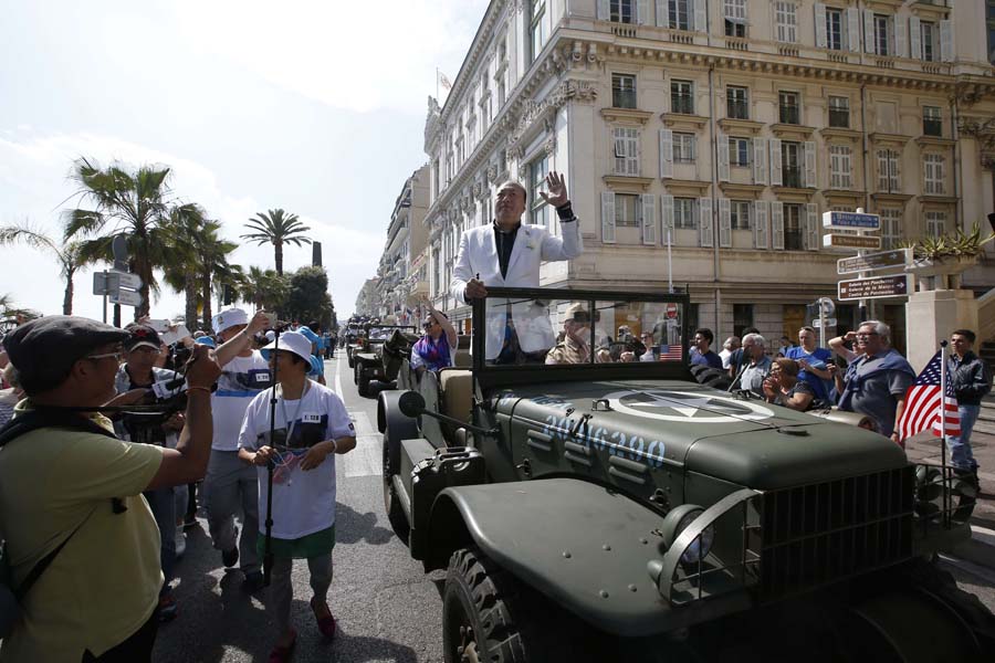 China Li Jinyuan chairman of Chinese company Tiens group parades on May 8, 2015 in the French Riviera city of Nice, where the company invited 6,400 of its employees for two days, to celebrate the 20th anniversary of their society. AFP PHOTO / VALERY HACHE