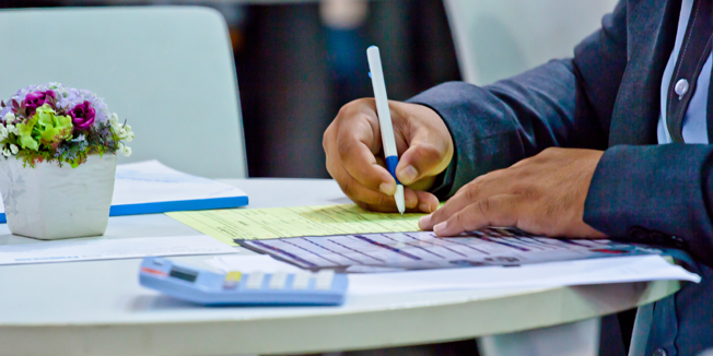 businessman writing with pen