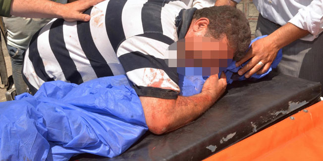 A Syrian man reacts over the body of his son following reported shelling by rebel fighters in Aleppo's Jamilia district, on the regime-held side of the northern city, on May 31, 2015. AFP PHOTO / GEORGE OURFALIAN