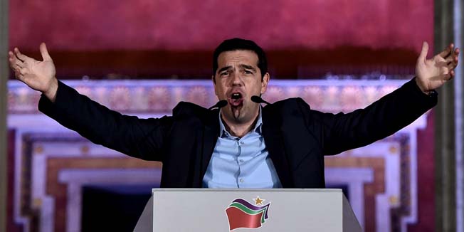 TOPSHOTSSyriza leader Alexis Tsipras greets supporters following victory in the election in Athens on January 25, 2015. The left-wing Syriza party led by Alexis Tsipras won Greece's general election  after campaigning on a pledge to renegotiate the country's international bailout and reverse years of spending cuts and painful economic reforms. AFP PHOTO / ARIS MESSINIS