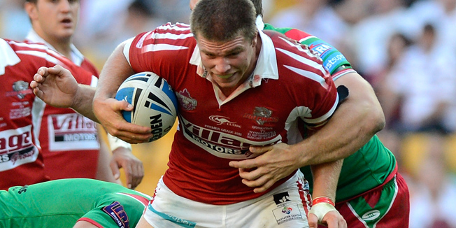 BRISBANE, AUSTRALIA - SEPTEMBER 23:  James Ackerman of the Dophins takes on the defence during the Intrust Super Cup Grand Final match between the Wynnum Manly Seagulls and the Redcliffe Dolphins at Suncorp Stadium on September 23, 2012 in Brisbane, Australia.  (Photo by Bradley Kanaris/Getty Images)