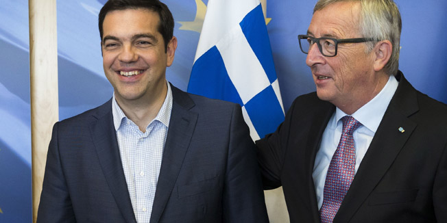 Greece's Prime Minister Alexis Tsipras (L) is welcomed by European Commission President Jean-Claude Juncker (R) ahead of a meeting on Greece, at the European Commission in Brussels, on June 24, 2015, as eurozone finance ministers try to finalise a debt deal and avoid a default by Athens. Greek Prime Minister Alexis Tsipras is set to conduct yet another round of crisis talks with representatives of the country's creditors, ahead of a crucial meeting of eurozone finance ministers where all sides hope a solution can be found to save the country from bankruptcy. AFP PHOTO / POOL / JULIEN WARNAND
