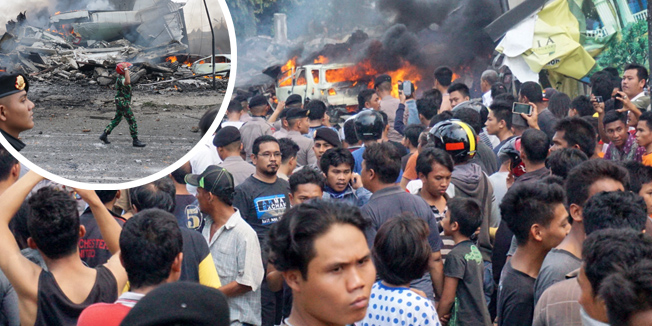 Residents gather next to the crash site of a military Hercules plane in Medan, North Sumatra province on June 30, 2015. An Indonesian military transport plane crashed shortly after take off in the city, an official said, with the plane exploding in a ball of flames. AFP PHOTO / Muhammad ZULFAN DALIMUNTHE