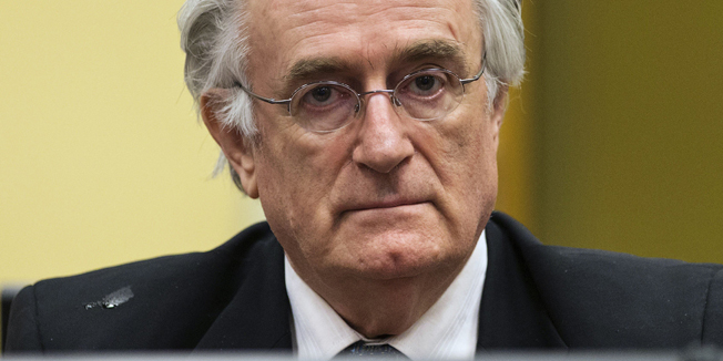 (FILES) -- This file picture taken on July 11, 2013 shows Bosnian Serb wartime leader Radovan Karadzic appearing in the courtroom for his appeal judgement at the International Criminal Tribunal for Former Yugoslavia (ICTY) in The Hague, The Netherlands. Former Bosnian Serb leader Radovan Karadzic will begin his closing statement on October 1, 2014 to the Yugoslav war crimes court, where he is charged with some of the worst atrocities in Europe since World War II. Accused of genocide, war crimes and crimes against humanity, Karadzic, 69, will have a final chance to convince the judges of his innocence, although a final verdict is not expected before late 2015.  AFP PHOTO/ POOL/MICHAEL KOOREN