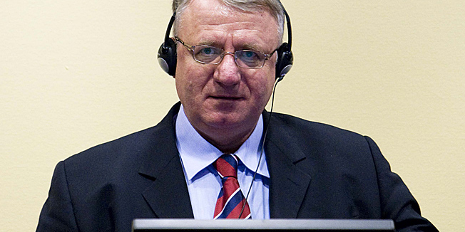 (FILES) A file photo taken on March 6, 2009 shows Serb ultranationalist leader Vojislav Seselj attending his trial on charges of crimes against humanity at the International Criminal Tribunal for the former Yugoslavia (ICTY) in The Hague. The tribunal is to rule on May 4, 2011 on a demand by Seselj to be acquitted for war crimes and crimes against humanity following the prosecution's presentation of evidence during the first stage of the process. He is charged with the persecution of Croat, Muslim and other non-Serb populations and their expulsion from areas of Croatia, Bosnia and Serbia between 1991 and 1994. AFP PHOTO/ POOL /VALERIE KUYPERS ***netherlands out - belgium out***