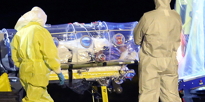 TOPSHOTSALTERNATIVE CROP A handout picture taken and released on September 22, 2014 by the Spanish Defence Ministry shows aid workers and doctors transferring Roman Catholic missionary Manuel Garcia Viejo who contracted the deadly Ebola virus, from Madrid's Torrejon air base to the Carlos III hospital upon their arrival in Spain.  Viejo, 69, director of a hospital in the Sierra Leonean town of Lunsar, 