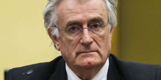 (FILES) -- This file picture taken on July 11, 2013 shows Bosnian Serb wartime leader Radovan Karadzic appearing in the courtroom for his appeal judgement at the International Criminal Tribunal for Former Yugoslavia (ICTY) in The Hague, The Netherlands. Former Bosnian Serb leader Radovan Karadzic will begin his closing statement on October 1, 2014 to the Yugoslav war crimes court, where he is charged with some of the worst atrocities in Europe since World War II. Accused of genocide, war crimes and crimes against humanity, Karadzic, 69, will have a final chance to convince the judges of his innocence, although a final verdict is not expected before late 2015.  AFP PHOTO/ POOL/MICHAEL KOOREN