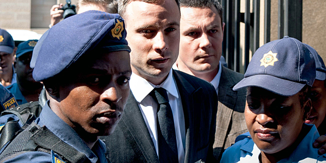 South African Paralympic athlete Oscar Pistorius arrives at the High Court in Pretoria on October 13, 2014. Fallen paralympic hero Oscar Pistorius returns to court today at the start of his sentencing hearing after he was convicted of culpable homicide in the killing of his girlfriend, with his lawyers set to argue for leniency. The double-amputee track star last month escaped a murder conviction in a verdict that shocked the country and fuelled criticism of South Africa's legal system. AFP PHOTO/STEFAN HEUNIS