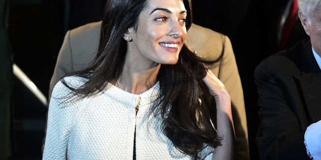 Amal Alamuddin Clooney (L) the human rights lawyer who recently married Hollywood superstar George Clooney in a lavish wedding in Venice, arrives to a central Athens hotel , as part of a team advising the government on the return of the Parthenon Marbles from Britain. AFP PHOTO/ LOUISA GOULIAMAKI