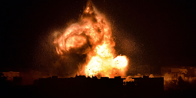 TOPSHOTSFlames rise from an explosion in the Syrian town of Kobane, also known as Ain al-Arab, after a US-led coalition strike as it seen from the Turkish border in the southeastern village of Mursitpinar, Sanliurfa province, on October 18, 2014. Turkey is turning a deaf ear to insistent pressure to take a more pro-active stance in the fight against Islamic State (IS) jihadists, adding to existing strains with the West under President Recep Tayyip Erdogan.  Western diplomats have repeatedly made clear they want to see the key NATO member play a key role in the coalition against the militants, who are battling for the Syrian town Kobane just a few kilometers from Turkey.           AFP PHOTO / ARIS MESSINIS