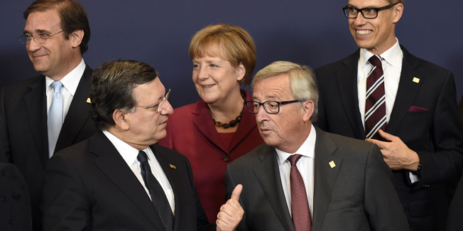 European Commission President  Jose Manuel Barroso (front L) talks with European Commission President-elect Jean-Claude Juncker before the official European heads of state and government family photo during a European Union summit at the EU headquarters in Brussels on October 23, 2014. The two-day summit of the European Council in Brussels will focus on an ambitious package of climate change targets for 2030 but also tackle the Ebola crisis, economic stagnation, concern over Ukraine and tension in Cyprus over Turkey. AFP PHOTO/JOHN THYS