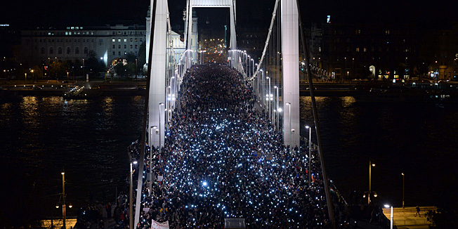 TO GO WITH AFP TEXT BY PETER MURPHYTen-thousand participants march accross the Elisabeth bridge during an anti-government rally against the goverment's new tax plan for the introduction of the internet tax next year in Budapest on October 28, 2014. AFP PHOTO / ATTILA KISBENEDEK