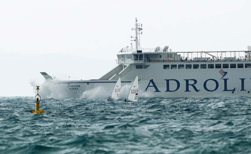 Split, 051114.Jako jugo koje u Dalmaciji puse brzinom od 25-30 cvorova uzrokuje poteskoce u pomorskom prometu i nudi ekstremne uvjete za rekreativce na moru. Na fotografiji: jedrilicari na treningu dok se Jadrolinijin trajekt probija do Supetra .Foto: Tom Dubravec / CROPIX
