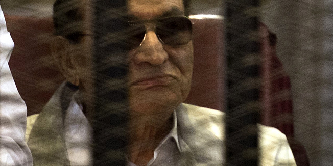 (FILES) Egyptian former president Hosni Mubarak is seen behind the defendants' cage during his retrial at the Police Academy in Cairo on June 8, 2013. Hosni Mubarak will face a new court hearing on August 21, 2013 during which his lawyer will seek his release from prison, judicial sources said. The hearing is the fourth and final case against the long-time president, who was toppled in a popular uprising in February 2011.  AFP PHOTO / KHALED DESOUKI