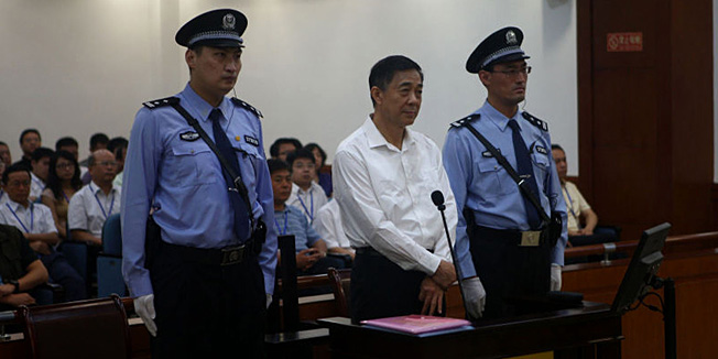 This picture taken on August 22, 2013 and released by the Jinan Intermediate People's Court's Weibo account shows former Chinese political star Bo Xilai (C) standing on trial in the Intermediate People's Court in Jinan, east China's Shandong province.  Bo Xilai went on trial for bribery, embezzlement and abuse of power on August 22, a court said, in the country's highest-profile prosecution for decades.  CHINA OUT    AFP PHOTO / JINAN INTERMEDIATE PEOPLE'S COURT ----EDITORS NOTE---- RESTRICTED TO EDITORIAL USE - MANDATORY CREDIT 