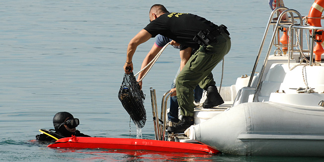 Kastel Sucurac, 031012.U moru ispred rive u samom centru Kastel Sucurca pronadjena su minsko eksplozivna sredstva. Pretpostavlja se da se radi o zaostalim bombama iz drugog svjetskog rata. Policija je blokirala citavo podrucje a pirotehnicari i ronioci MUP-a su zapoceli sa vadjenjem eksplozivnih sredstava.Na fotografiji vadjenje mina iz mora.Foto: Mario Todoric / CROPIX