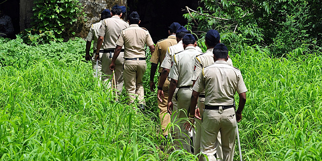 Indian policemen walk into the Shakti Mills compound, the scene of last week's gang rape of a female photojournalist, in Mumbai on August 28, 2013. Mumbai police August 28 took the five arrested suspects to the crime scene of an abandoned mill compound for a reconstruction of events. Mumbai's top policeman has drawn anger in the wake of the gang-rape of a young photographer by suggesting that people must choose between a 