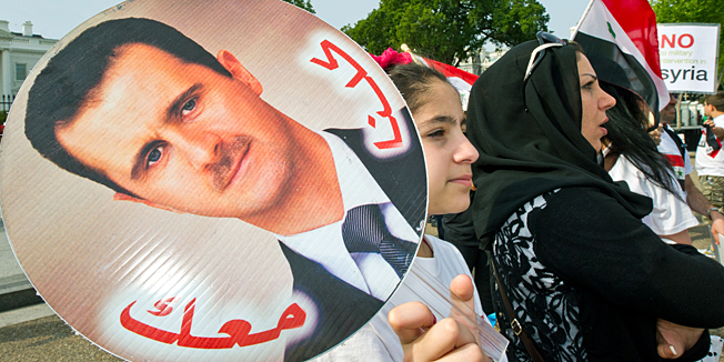 Supporters of Syrian President Bashar Al-Assad take part in a demonstration in front of the White House in Washington, DC, on September 9, 2013 urging the US not to attack Syria. US Presidents Barack Obama and Bashar Al-Assad will go head-to-head in dueling US television interviews Monday, as a crucial week dawns for the US leader's push for air attacks on Syria. Assad denied that he used chemical weapons on civilians, as Obama makes a long-odds push to reverse his nation's mood and win support for punishing the Damascus regime for flouting taboos on the use of such arms. AFP PHOTO/ Karen BLEIER
