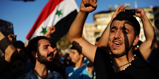 Protesters shout slogans during a rally against a possible attack on Syria in response to alleged use of chemical weapons by the Assad government on September 1, 2013, in Hatay. US President Barack Obama said on September 1 he will ask the US Congress to authorize military action against Syria, lifting the threat of immediate strikes on President Bashar al-Assad's regime. Obama said he had decided he would go ahead and launch military action on Syria, but he believed it was important for American democracy to win the support of lawmakers.  AFP PHOTO / BULENT KILIC