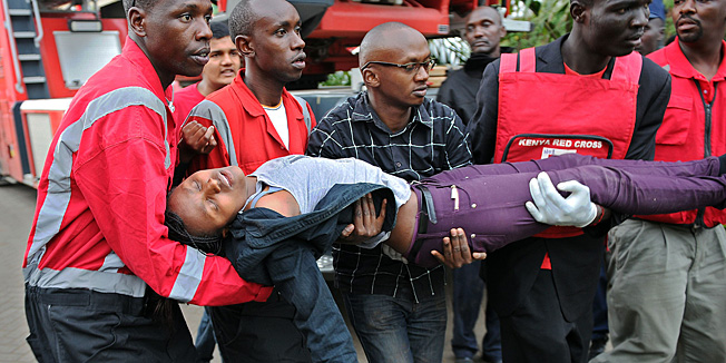 TOPSHOTSA woman who had been held hostage is carried in shock by rescue personnel on September 21, 2013, after she was freed following a security operation at an upmarket shopping mall in Nairobi where suspected terrorrists engaged Kenyan security forces in a drawn out gun fight. Some 20 people have been killed and about 50 wounded Saturday in the initial attack by the gunmen the Kenya Red Cross said.  AFP PHOTO / Tony KARUMBA