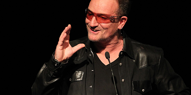 Singer with Irish Rock band U2, Bono, speaks before awarding Pakistani student who was shot in the head by the Pakistani Taliban, Malala Yousafzai the Amnesty International Ambassador of Conscience Award for 2013 at the Manison House in Dublin, Ireland on September 17, 2013.  The Ambassador of Conscience Award is Amnesty International's highest honour, recognizing individuals who have promoted and enhanced the cause of human rights through their life and by example. Malala Yousafzai, 16, is an advocate for equal access to education. In 2012 she was shot and severely wounded in an attack claimed by the Pakistani Taliban. AFP PHOTO/ PETER MUHLY