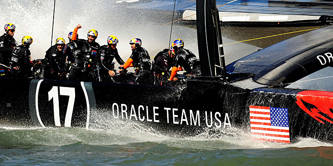 Oracle Team USA celebrates as they come in to win race 18 of the 34th America's Cup on September 24, 2013 in San Francisco.  Oracle Team USA sailed to an unprecedented seventh consecutive America's Cup victory, extending an epic comeback to pull level with Emirates Team New Zealand at eight triumphs each.AFP PHOTO/Josh Edelson