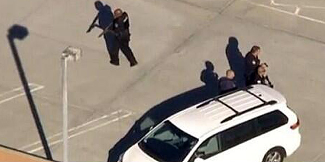 This image released by the Los Angeles Police Department (LAPD), shows an armed LAPD officer is seen patrolling the Los Angeles International Airport on November 1, 2013. At least two people were injured Friday in a shooting incident at the airport, parts of which were evacuated as police swarmed into the area, officials and reports said. But police said there was 