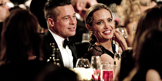 Honoree Angelina Jolie (R) and actor Brad Pitt attend the 2013 Governors Awards, presented by the American Academy of Motion Picture Arts and Sciences (AMPAS), at the Grand Ballroom of the Hollywood and Highland Center in Hollywood, California, November 16, 2013.  AFP PHOTO / Robyn Beck