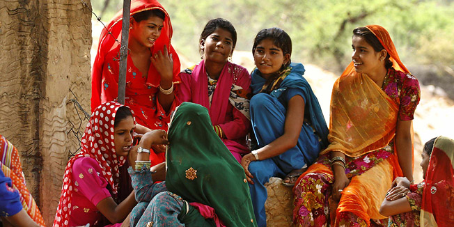 In this photo taken Friday, June 10, 2011, girl child laborers rest in the shade of a tree at a construction site on the outskirts of Pushkar, in the northern Indian state of Rajasthan. According to the United Nations, 150 million children across the world are engaged in child labor. Indian officials estimated a few years ago that 13 million children work in India. Rights activists, however, place the number of child workers as high as 60 million, with one estimate saying that 20 percent of India's economy is dependent on children under 14. (AP Photo/Rajesh Kumar Singh)