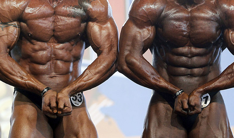 Competitors flex their muscles during the semifinal of the Arnold Classic Europe bodybuilding event in Madrid, Spain, Saturday, Oct. 13, 2012. (AP Photo/Andres Kudacki)