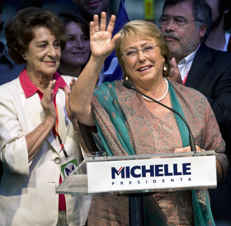 Chilean president-elect, Michelle Bachelet, waves as she celebrates after getting the results of the run-off presidential election in Santiago on December 15, 2013. Socialist Michelle Bachelet was swept back into office Sunday as Chile's next president, on a platform of boosting education and narrowing the gap between rich and poor. AFP PHOTO/MARTIN BERNETTI