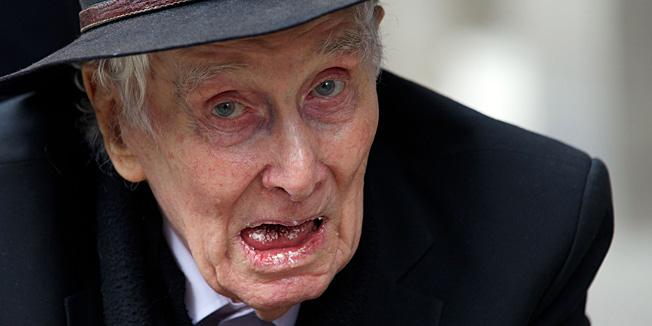 (FILES) In this file picture taken on March 20, 2013 Ronnie Biggs, 83 notorious for his role in the Great Train Robbery of 1963 gestures to waiting photographers as he arrives to attend the funeral of the mastermind of the robbery,  Bruce Reynolds at Priory Church of Saint Bartholomew the Great in central London .  Ronnie Biggs, 83 notorious for his role in the Great Train Robbery of 1963 died on December 18, 2013.  AFP PHOTO / ANDREW COWIE