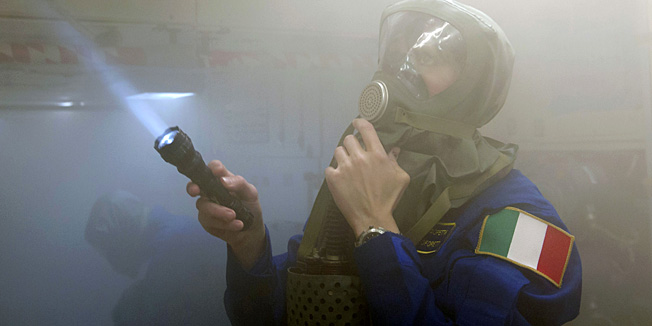Wearing gas mask European Space Agency Italian astronaut Samantha Cristoforetti takes part in a preflight training session at the Gagarin Cosmonauts' Training Centre in Star City centre outside Moscow, on December 11, 2013. Cristoforetti is scheduled to blast off to the International Space Station (ISS) from the Russian leased Kazakhstan's Baikonur cosmodrome in November 2014. AFP PHOTO