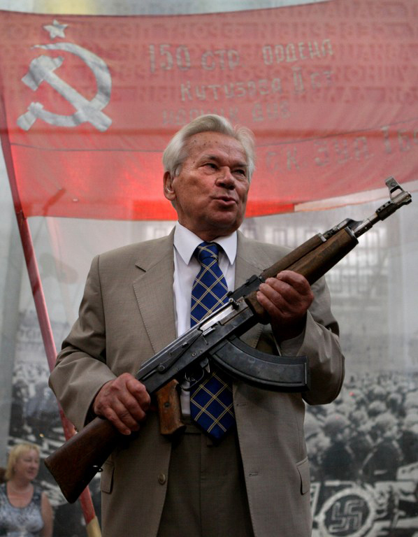 (FILES) -- A file picture taken on July 6, 2007 shows famous Russian weapon designer Mikhail Kalashnikov, posing at age 87 with the first model of his legendary AK-47 assault rifle during a ceremony in Moscow celebrating the 60th anniversary of the rifle. Kalachnikov died on December 23, 2013, aged 94, announced Russia's ITAR-TASS news agency. Kalashnikov designed a weapon that became synonymous with killing on a sometimes indiscriminate scale but was seen in the Soviet Union as a national hero and symbol of Moscow's proud military past.   AFP PHOTO/ DIMA KOROTAYEV