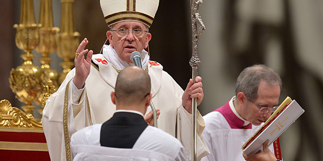 Pope Francis blesses the crowd at the end of a Christmas Eve mass at St Peter's Basilica to mark the nativity of Jesus Christ, on December 24, 2013 at the Vatican.  AFP PHOTO / FILIPPO MONTEFORTE