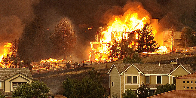 The Waldo Canyon fire burns an entire neighborhood in near the foothills of Colorado Springs, Colo. Tuesday, June 26, 2012. Colorado has endured nearly a week of 100-plus-degree days and low humidity, sapping moisture from timber and grass, creating a devastating formula for volatile wildfires across the state and punishing conditions for firefighters. (AP Photo/The Denver Post, Helen H. Richardson)  MAGS OUT; TV OUT; INTERNET OUT  