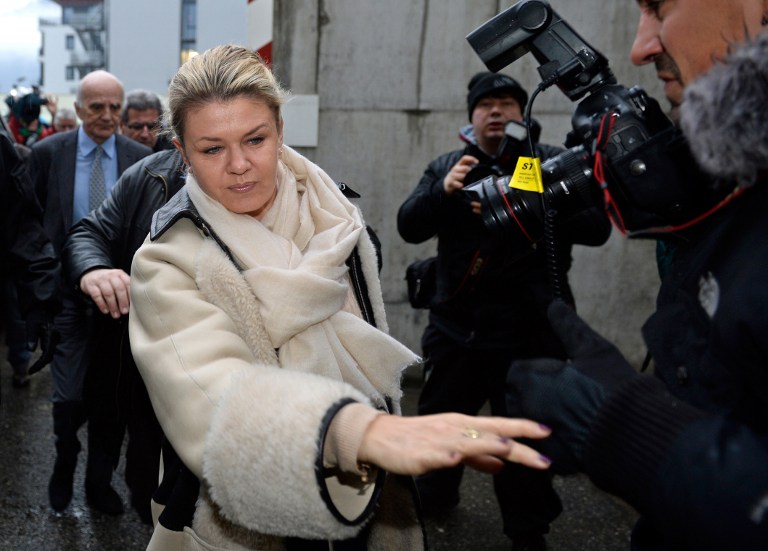(FILES) A photo taken on January 3, 2014 shows Corinna Schumacher, the wife of German Formula One world champion Michael Schumacher, arriving at the Grenoble University Hospital Centre with French surgeon professor Gerard Saillant (L), to visit her husband who lies in a coma following a skiing accident. Michael Schumacher's wife called on reporters on January 7, 2014 to stay away from the French hospital where he is being treated for life-threatening injuries, and to leave her family alone. AFP PHOTO/PHILIPPE DESMAZES
