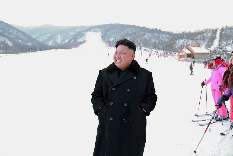 This undated picture released by North Korea's official Korean Central News Agency (KCNA) on December 31, 2013 shows North Korean leader Kim Jong-Un (C) inspecting a ski resort on Masik Pass to be completed in Kangwon province.  Kim Jong-Un visited the newly completed ski resort and ordered officials to open his pet project to the public as soon as possible, state media reported.  Kim took a test ride on a ski lift at the Masik Pass Ski Resort, which he said during a visit two weeks ago was 