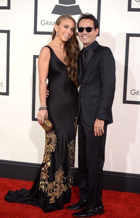Marc Anthony (R) and Chloe Green arrive on the red carpet for the 56th Grammy Awards at the Staples Center in Los Angeles on January 26, 2014.    AFP PHOTO ROBYN BECK