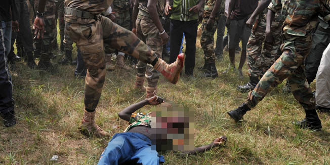 GRAPHIC CONTENT Members of the Central African Armed Forces (FACA) lynch to death a man suspected of being a former Seleka rebel on February 5, 2014, in Bangui. The impoverished former French colony descended into chaos last March when rebel forces overthrew the president, but an interim government lost control of the country. Rival Muslim and Christian militias are now battling each other and rogue checkpoints have been set up on nearly all main roads.Despite the presence of French and African peacekeeping troops, violence continues to rock the country, and has already forced about a fifth of the population of 4.6 million from their homes.AFP PHOTO/ ISSOUF SANOGO 