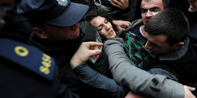TOPSHOTSProtesters confront with policemen during a demonstration, in front of the local education authority of Pristina's University, to ask for the resignation of the university's chancellor Ibrahim Gashi and the removal of scientific titles for professors that have published in false scientific magazines, on February 6, 2014. AFP PHOTO/ARMEND NIMANI