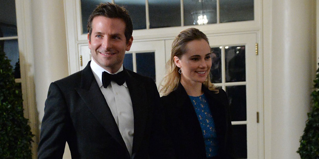 Actor Bradley Cooper and Suki Waterhouse arrive at the White House in Washington on February 11, 2014 for the state dinner in honor of French President Francois Hollande.  Hollande is on a three-day visit to the US.   AFP PHOTO/Nicholas KAMM