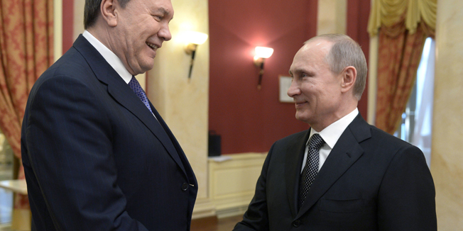 Russia's President Vladimir Putin (R) shakes hands with his Ukrainian counterpart Viktor Yanukovych before the official reception held on behalf of Russian President in honor of the distinguished guests of the XXII Olympic Winter Games.in Sochi, on February 7, 2014. Putin will welcome to the Sochi Olympic Games dozens of world leaders supportive of his rule but heads of state of big Western countries will be conspicuous by their absence. AFP PHOTO/ RIA-NOVOSTI/ POOL / ALEXEI NIKOLSKY