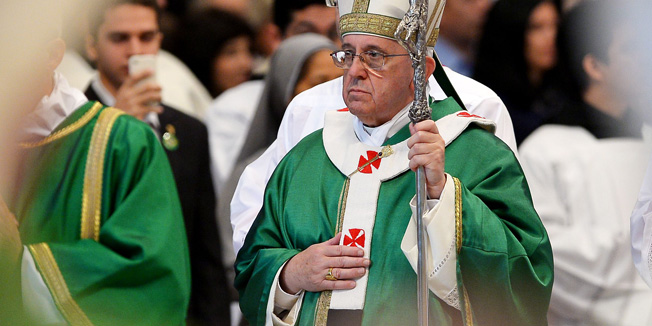 Pope Francis (L) leaves after celebrating holy mass together with new appointed cardinals in St Peter's basilica at the Vatican on February 23, 2014. Pope Francis create his first batch of cardinals, with 19 coming from South America, Africa and Asia. The new 