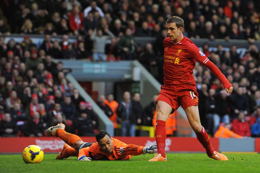 Liverpool's English midfielder Jordan Henderson (R) scores his team's fourth goal past Swansea City's Dutch goalkeeper Michel Vorm (L) during the English Premier League football match between Liverpool and Swansea City at Anfield in Liverpool, northwest England on February 23, 2014. AFP PHOTO / ANDREW YATESRESTRICTED TO EDITORIAL USE. No use with unauthorized audio, video, data, fixture lists, club/league logos or live services. Online in-match use limited to 45 images, no video emulation. No use in betting, games or single club/league/player publications.