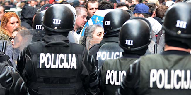 Bosnian citizens' rights activists argue with riot police as they gather in front of Bosnia and Herzegovina's Presidency building in country's capital Sarajevo, on February 9, 2014. Several hundred people continued to protest in Sarajevo, demanding from politicians of all levels of government to resign. Bosnia was hit by fresh protests against unemployment and corruption Saturday but the demonstrations were mostly peaceful as the country was left reeling from three days of rioting in the worst unrest since the 1992-1995 war.  AFP PHOTO / ELVIS BARUKCIC