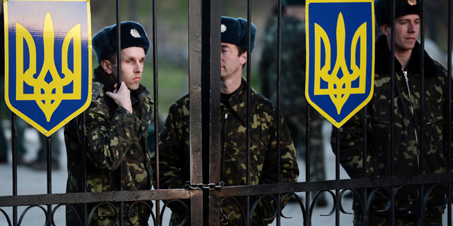 Ukranian soldiers stand guard inside the Sevastopol tactical military brigade base near Balbek in Sevastopol, on March 3, 2014. Russian forces have given Ukrainian soldiers an ultimatum to surrender their positions in Crimea or face an assault, a Ukrainian defence ministry spokesman told AFP.  AFP PHOTO / FILIPPO MONTEFORTE